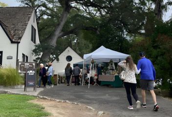 A couple walking up to a pop up vendor